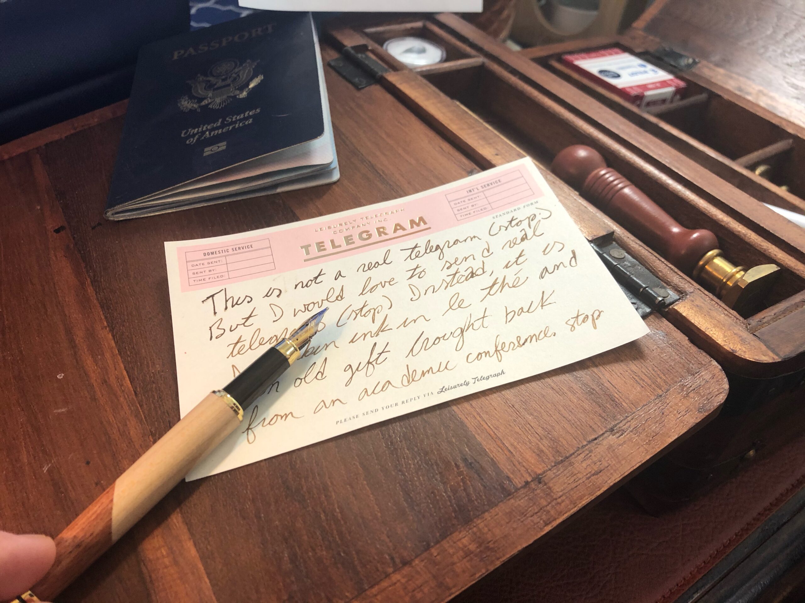 Portable Writing Desk with Passport, small note, and fountain pen.